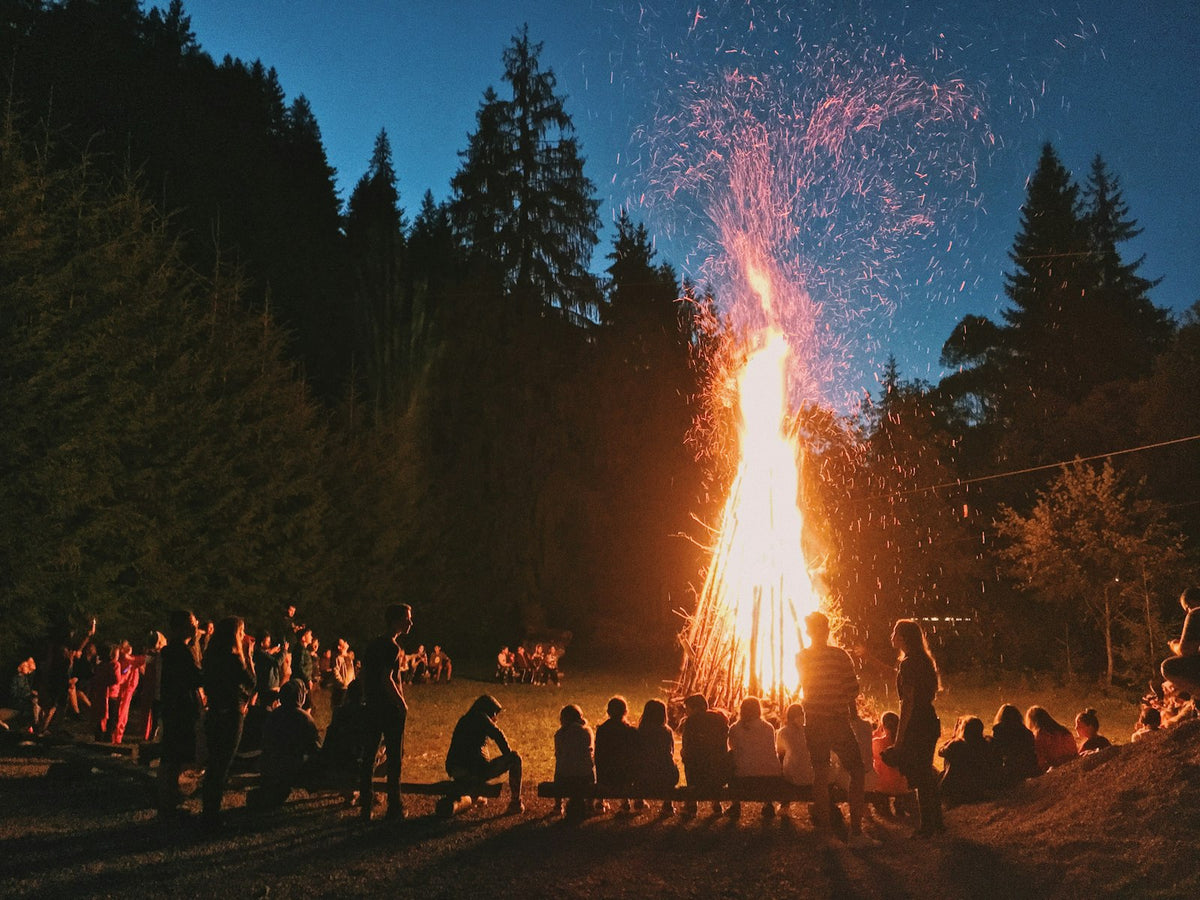 People gathered around a bonfire at night