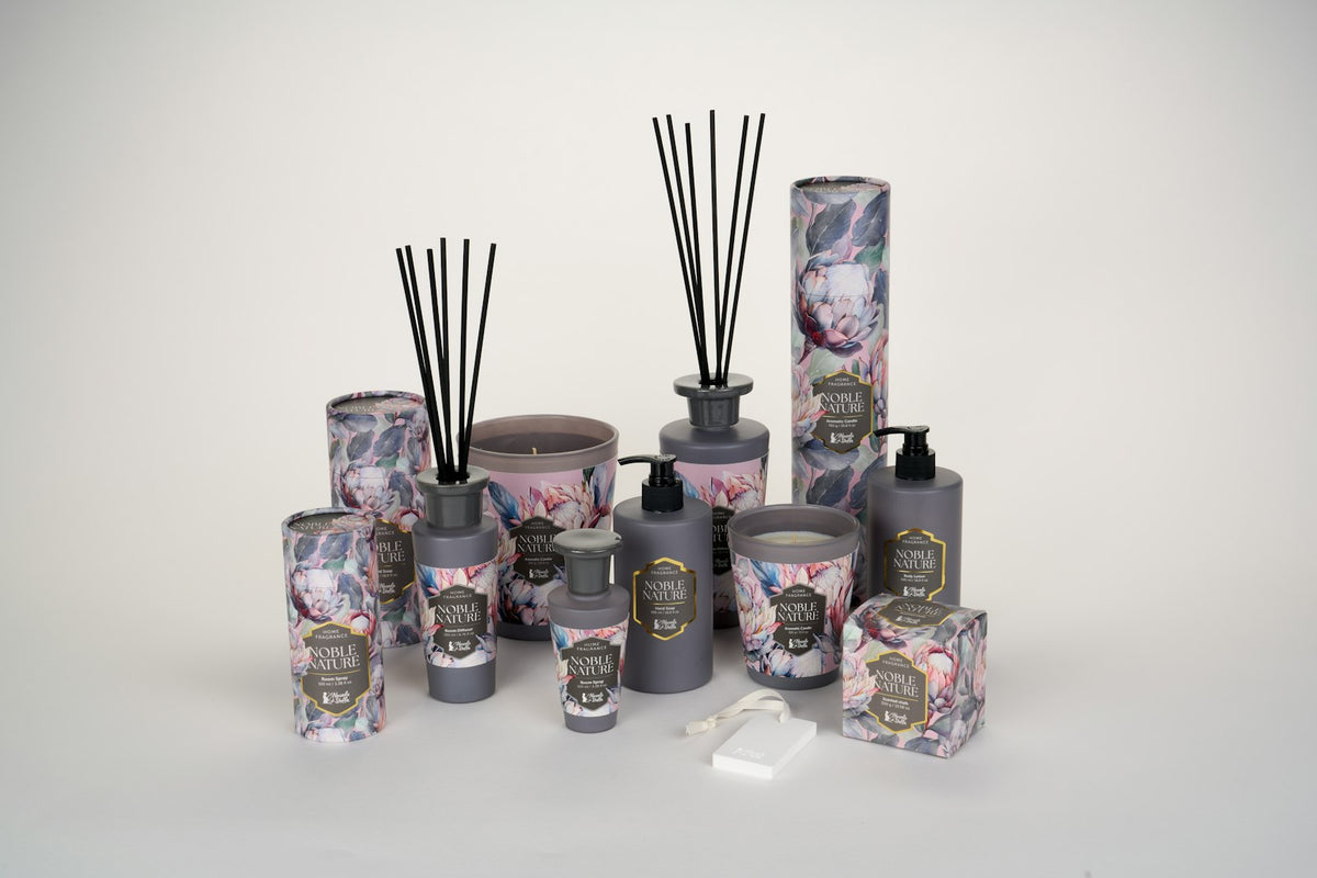 Home fragrance products on a pale surface