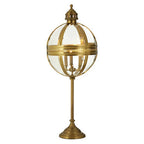 Brass globe table lamp with decorative grille and glass globe