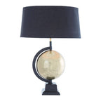 Antique brass globe lamp in a study setting