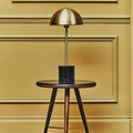 Brushed brass dome table lamp on a black marble base