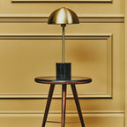 Brushed brass dome table lamp on a black marble base