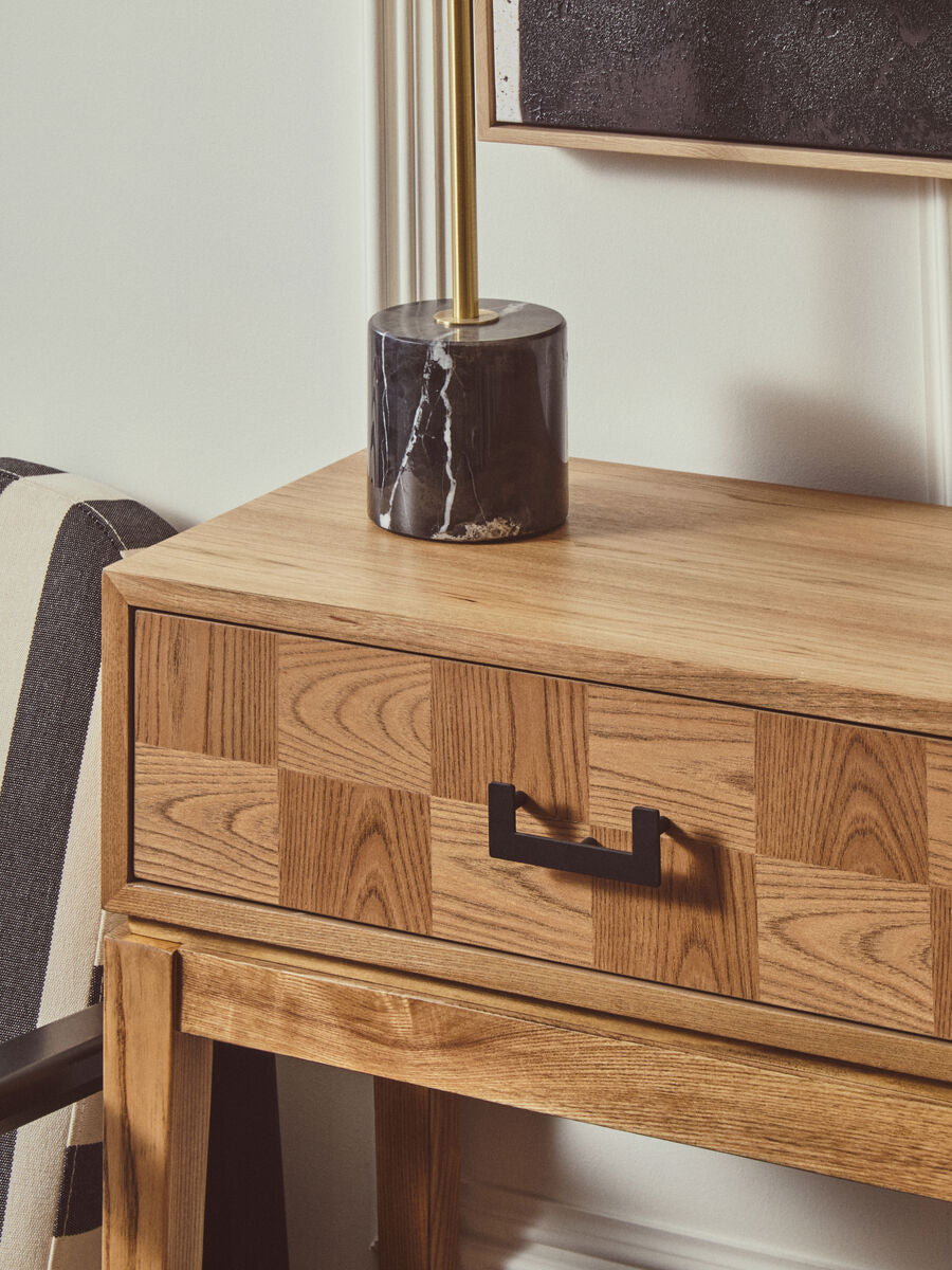 Detail of the black marble base and brushed brass stem