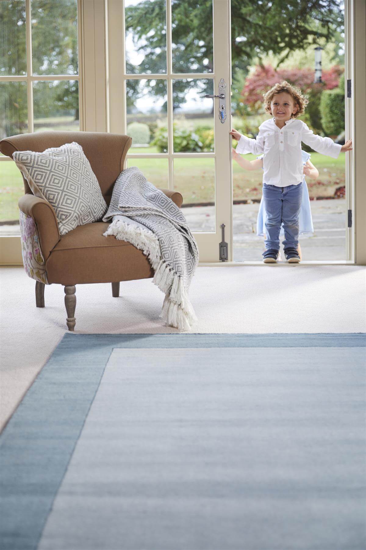 Duck egg blue bordered wool rug in a room