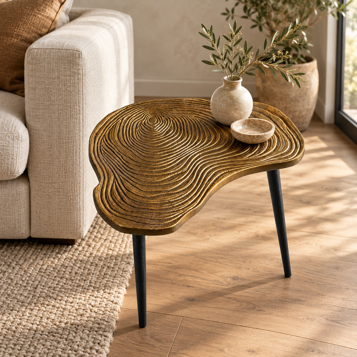 Brass clover side table beside a chair