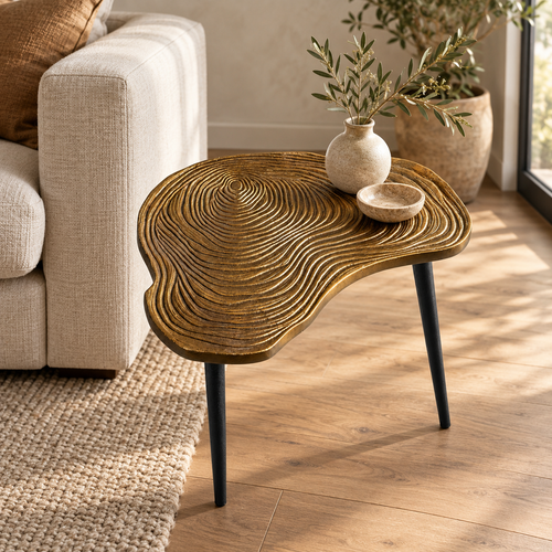 Brass clover side table beside a chair