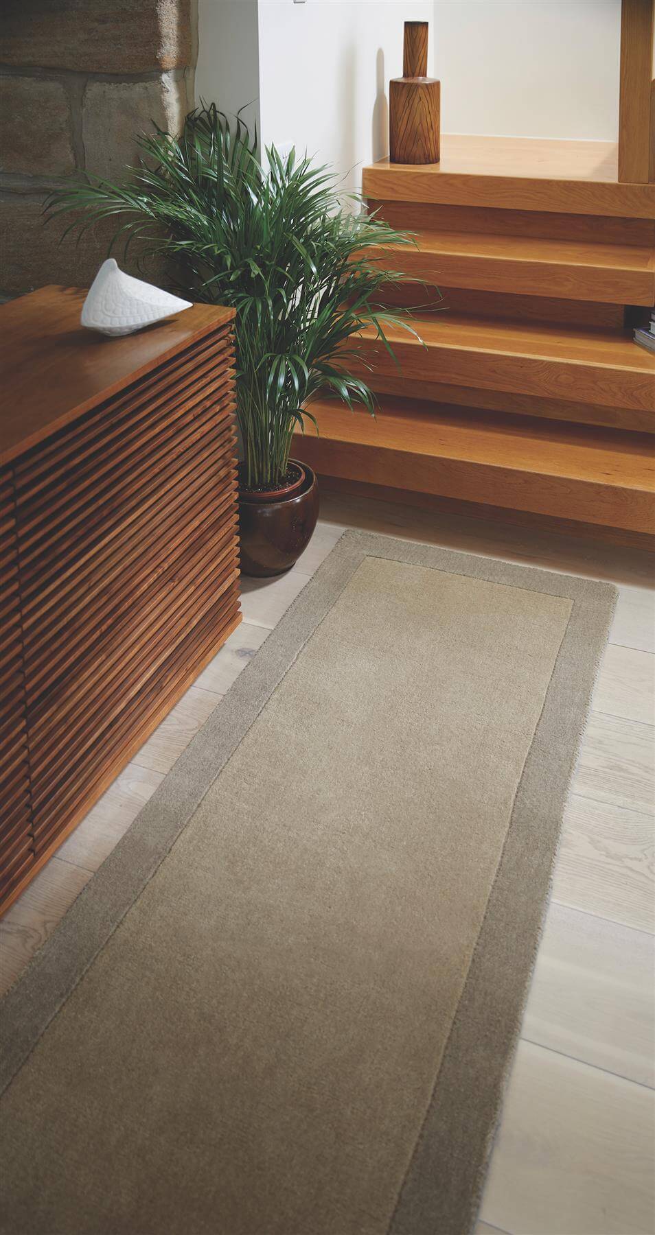 Close view of the taupe wool pile and border