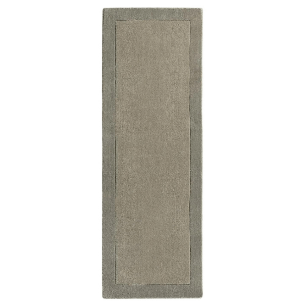 Taupe bordered wool rug in a room