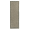 Taupe bordered wool rug in a room