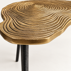 Detail of the etched clover pattern on the brass-coloured top